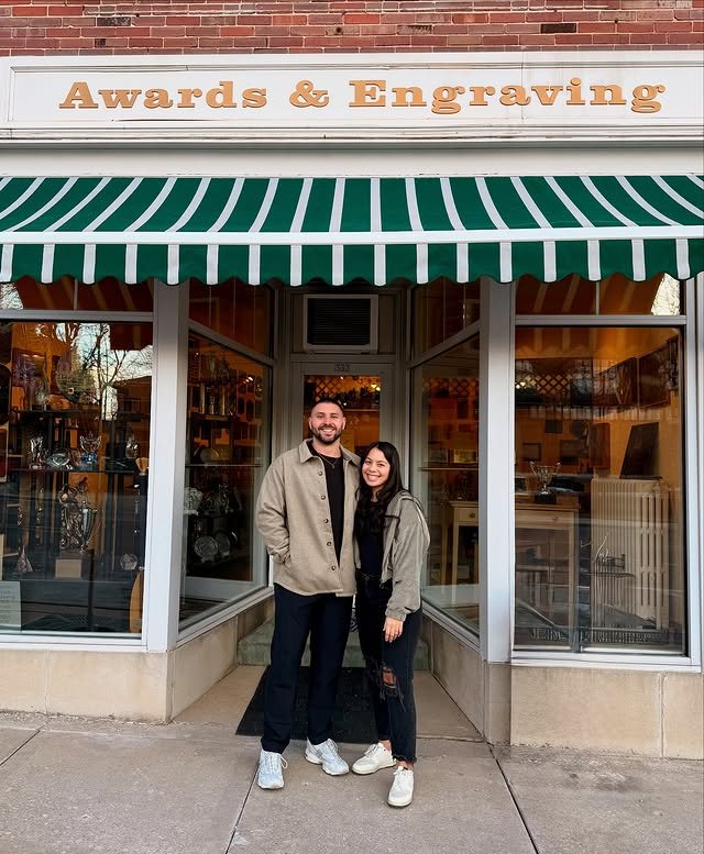 Owners Daniel and Bailey Mattson at the Awards & Engraving storefront
